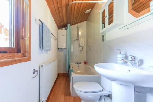 a bathroom with a sink and a toilet and a tub at Wharfe Lodge in Skipton