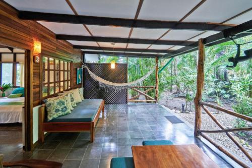 a living room with a hammock in a house at Hotel Tropico Latino in Santa Teresa Beach