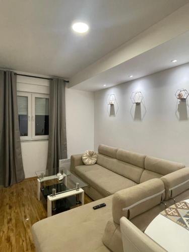 a living room with a couch and a table at Stan na dan Bratunac in Bratunac