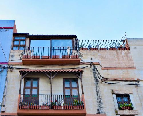 a building with windows and balconies on top of it at Hidden Gems in Hamrun