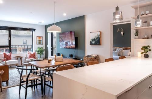 a kitchen and living room with a table and chairs at Hemlock Hangout by Revelstoke Vacations in Revelstoke