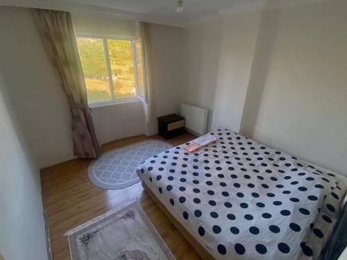 a small bedroom with a bed and a window at Airport apartements in Arnavutköy