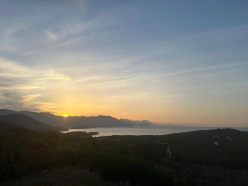 a sunset over a body of water with mountains at Villa Azure Krimovica Kotor in Krimovice