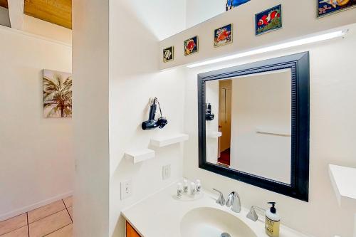 a bathroom with a sink and a mirror at Kona Bali Kai #351 in Kailua-Kona