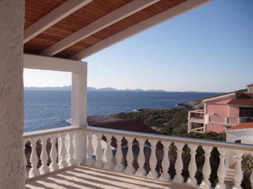 a balcony with a view of the ocean at Apartments Malo Misto in Zavalatica