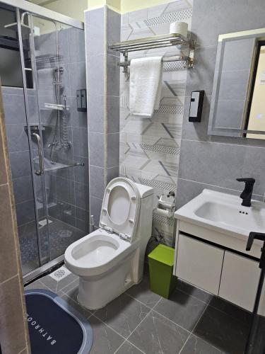 a bathroom with a toilet and a sink and a shower at Cosynook Home Valley Heights in Nairobi