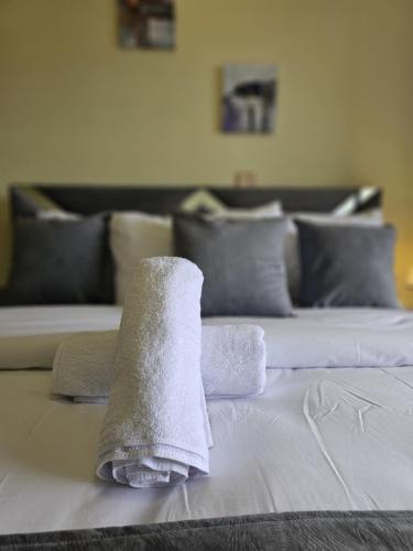 a pile of towels sitting on top of a bed at Cosynook Home Valley Heights in Nairobi