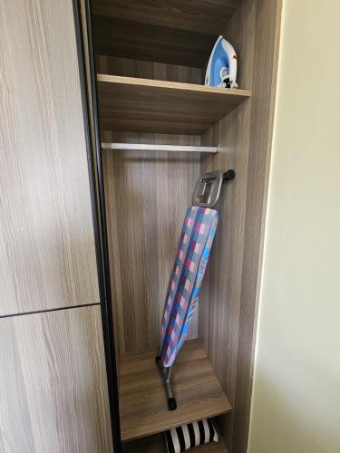 a striped umbrella in a wooden book shelf at Cosynook Home Valley Heights in Nairobi