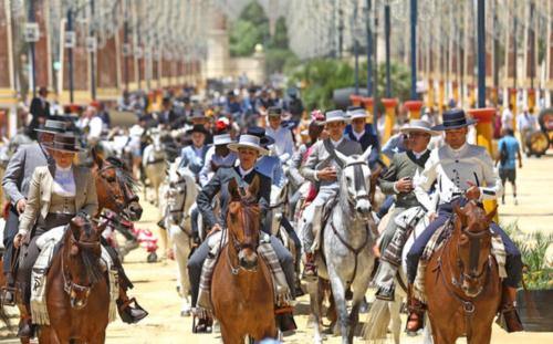 a group of people riding horses down a street at La Terraza de Porvenir 10 - Jerez de la Frontera in Jerez de la Frontera