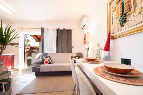 a living room with a table and a couch at Apartment Opatija with Garden and Seaview in Opric