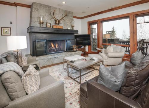 a living room with couches and a fireplace at Hummingbird C102 Condo in Beaver Creek