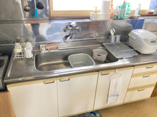 a kitchen counter with a sink and a mixer at 静かな田舎の一軒家～空き家を活用したDIY住宅～ 