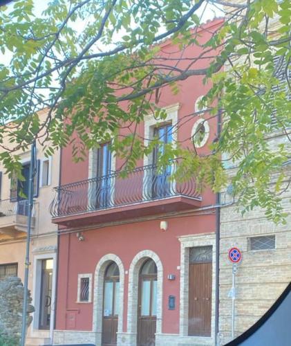 a pink building with a balcony on top of it at RESIDENZA IN PIAZZETTA in Vasto