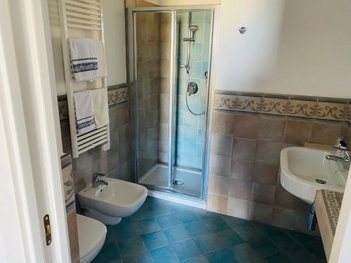 a bathroom with a shower and a toilet and a sink at RESIDENZA IN PIAZZETTA in Vasto