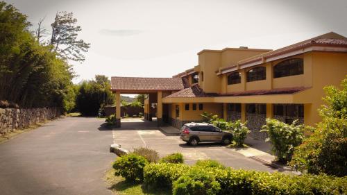 a car parked in a parking lot in front of a building at Hotel Montaña Monteverde in Monteverde Costa Rica