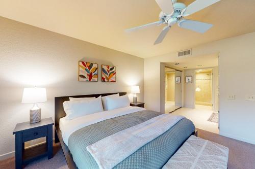 a bedroom with a bed and a ceiling fan at Palms & Peaks, Unit F37 Permit #43588 in Palm Springs