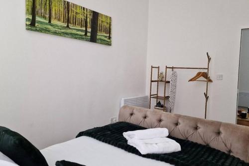 a bedroom with a bed with two towels on it at Cosy 2 Bedroom Apartment in Birmingham