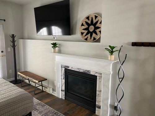 a living room with a fireplace and a television at Winter Park Chateau in Winter Park