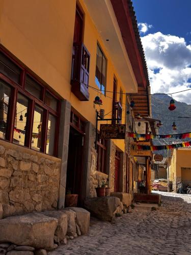 a street in a town with buildings and flags at Casa D´Maria in Ollantaytambo