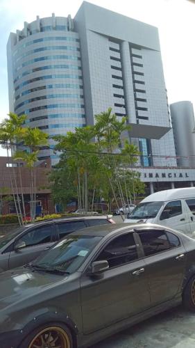 a car parked in a parking lot in front of a building at Orchid Homestay in Labuan