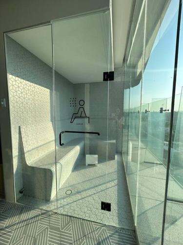 a glass walled bathroom with a tub and a sink at Departamento Cielo Bucerias, Beach Front Nayarit in Bucerías