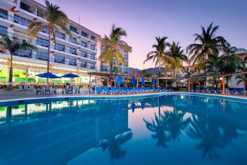 a swimming pool in front of a hotel at Costa Club Punta Arena - Desayuno buffet incluido in Puerto Vallarta