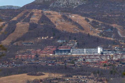 a town in front of a mountain with a building at Radisson Blu Resort, Beitostølen in Beitostøl