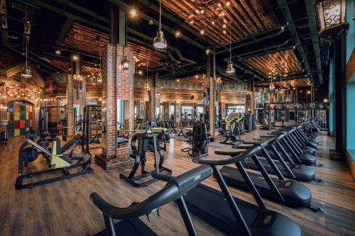 a gym with rows of treadmills and machines at Radisson Hotel & Residences Erbil in Erbil