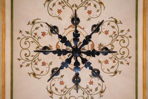 a chandelier hanging on a wall with flowers at Los Pilares Hotel in Oaxaca City