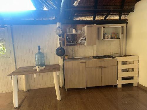 una cocina con una mesa con una botella. en Nature Harmony Retreat in Tierra Bomba - Your Sustainable Escape, en Cartagena de Indias