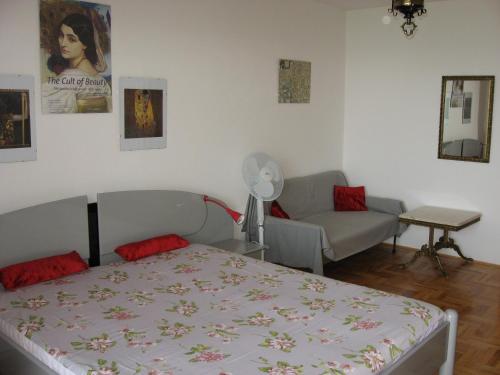 a bedroom with a bed and a couch in it at Apartments Sopaljska 24a in Crikvenica