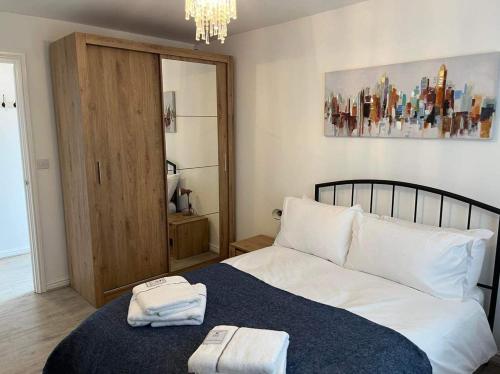 a bedroom with a bed with two towels on it at The Arrows Bungalow in Waddington