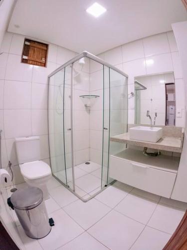 a bathroom with a shower and a toilet and a sink at Flat na natureza in Bonito