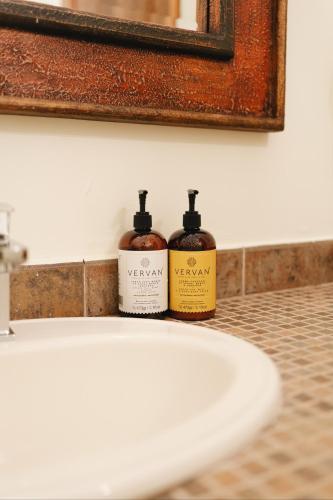 two bottles of soap sitting on top of a sink at Los Pilares Hotel in Oaxaca City