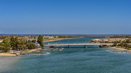a view of a river with a bridge and a beach at Bridgepoint 1105 in Mandurah