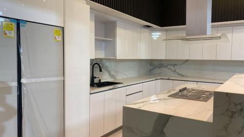 a white kitchen with a sink and a counter at Mansión Casa Bali in San Andrés