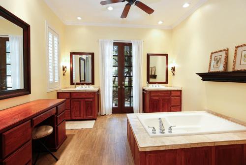 a large bathroom with a large tub and two sinks at Luxury Golf Course Private Retreat with Heated Swimming Pool in Horseshoe Bay