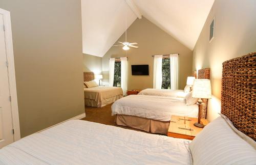 a bedroom with two beds and a tv in it at Luxury Golf Course Private Retreat with Heated Swimming Pool in Horseshoe Bay