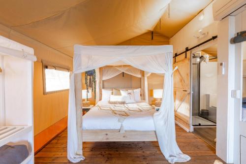 a bedroom with a bed in a tent at NRMA Phillip Island Beachfront Holiday Park in Cowes