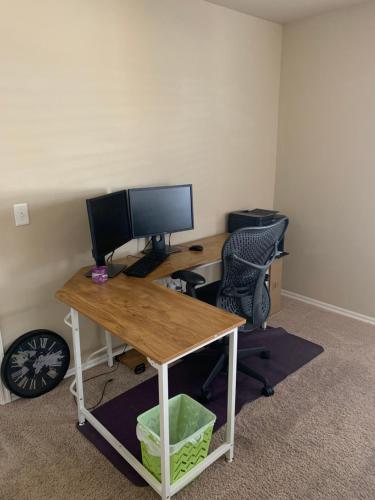 an office with a desk with a computer and a chair at Cheerful 3 Bdrm space, 2 bath!. You gotta love it! in Oklahoma City