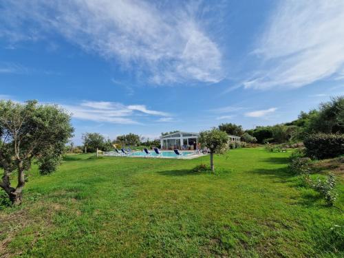 a park with a swimming pool in a field at 309 Le Saline - Stintino in Stintino