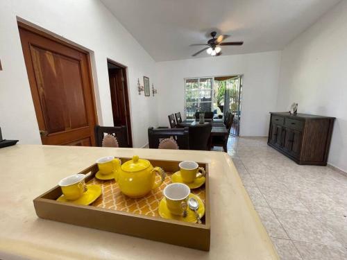 a living room with a table with yellow pots and pans at Relax House in Concepción de La Vega