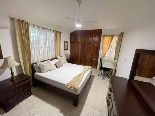 a bedroom with a bed and a dresser and a television at Relax House in Concepción de La Vega