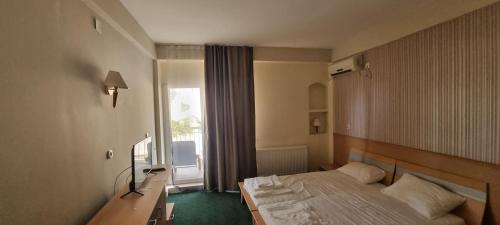 a hotel room with a bed and a window at HOTELS ELSA in Skopje