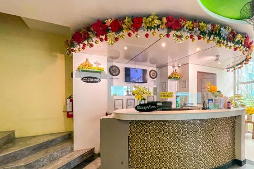 a restaurant with a counter with flowers on the ceiling at Cebu Capitol Central Hotel & Suites powered by Cocotel in Cebu City
