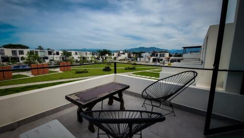 a balcony with a wooden table and two chairs at Casa Mayawell in Las Juntas