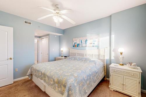 a bedroom with a bed and a ceiling fan at Captiva Bay 202 in Ocean City