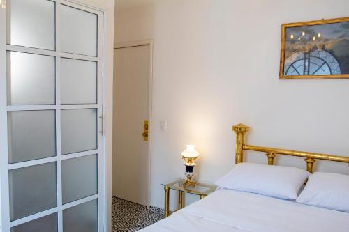 a bedroom with a bed and a glass door at Casa Zepeda in Atlixco