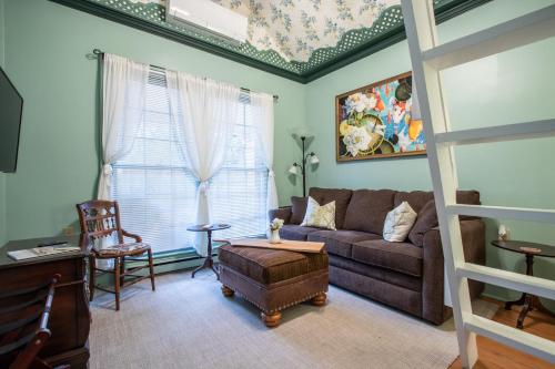 a living room with a couch and a chair at The Oaks Victorian Inn in Christiansburg