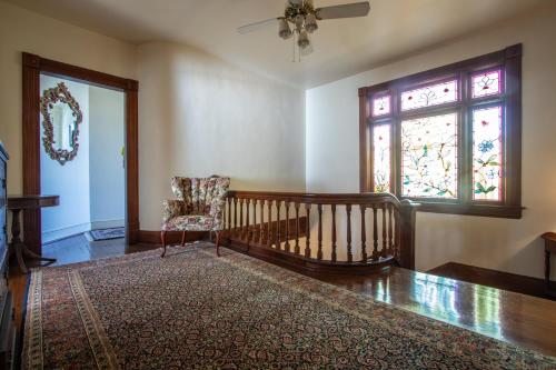 a living room with a chair and a window at The Oaks Victorian Inn in Christiansburg